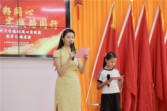 实践团成员与塔什米里克乡青少年共同主持成果汇报展演